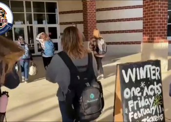 Students at Woodgrove High School in Loudoun County, Virginia walk into school without masks even though the school district said it would defy Gov. Glenn Youngkin’s executive order making it optional