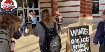 Students at Woodgrove High School in Loudoun County, Virginia walk into school without masks even though the school district said it would defy Gov. Glenn Youngkin’s executive order making it optional